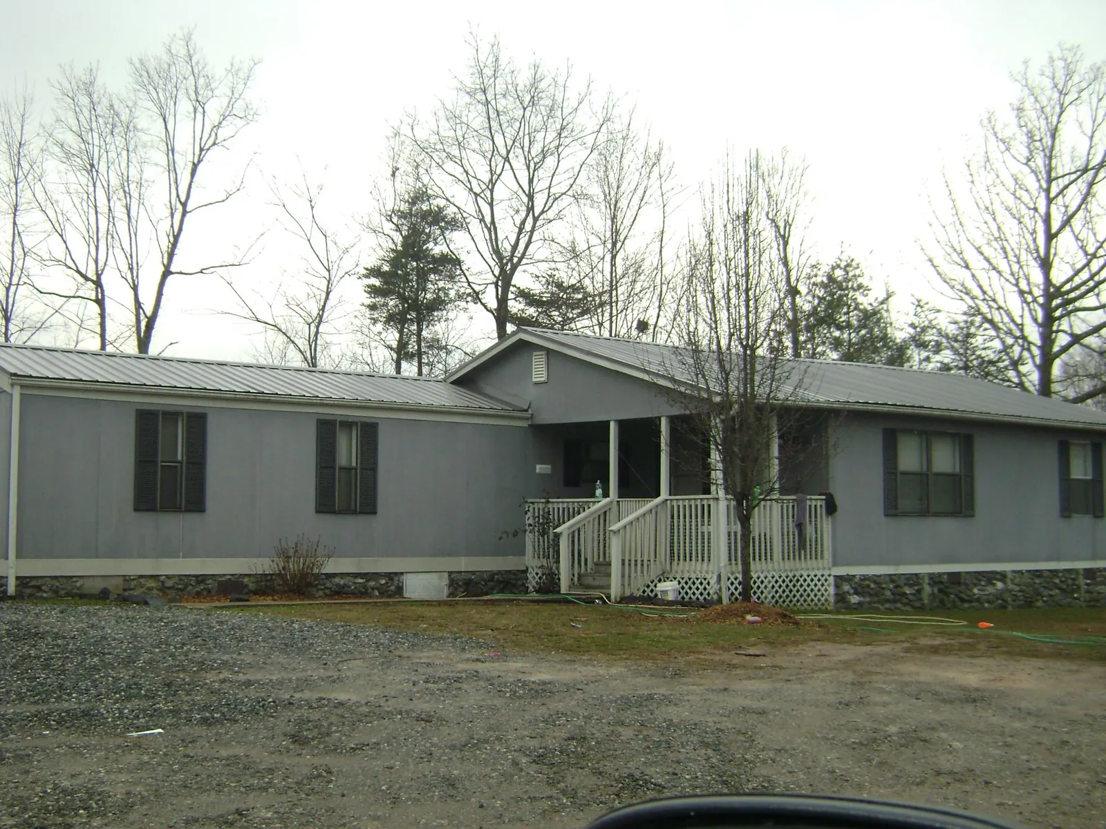 Metal roof over a manufactured home with a covered front porch in Orleans